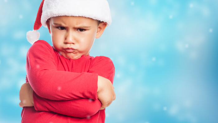 portrait of a little boy on christmas time with angry gesture